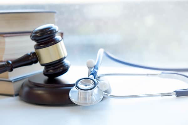 Gavel and stethoscope. medical jurisprudence. legal definition of medical malpractice. attorney. common errors doctors, nurses and hospitals make.