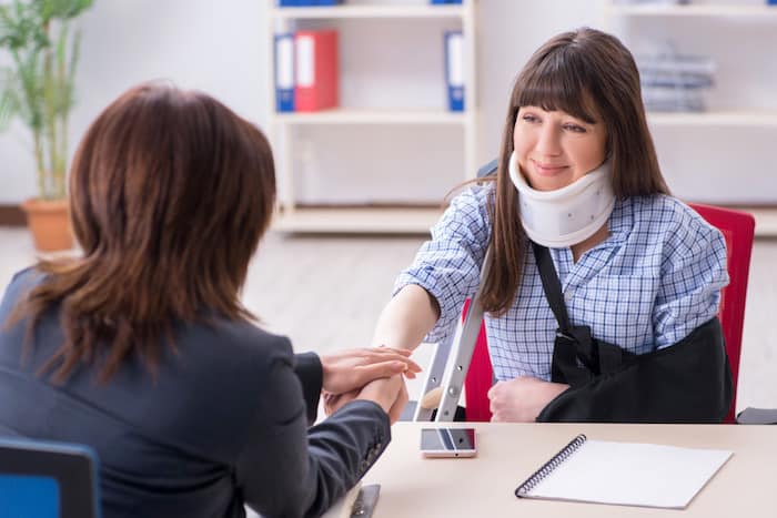 Injured employee visiting lawyer for advice on insurance