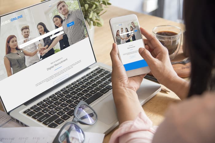 Woman looking for online jobs from HR head hunter recruitment website.