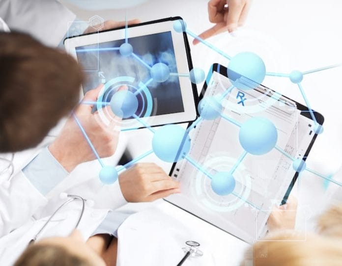 healthcare, technology, medicine and people concept - group of doctors with tablet pc, clipboard and molecular projection