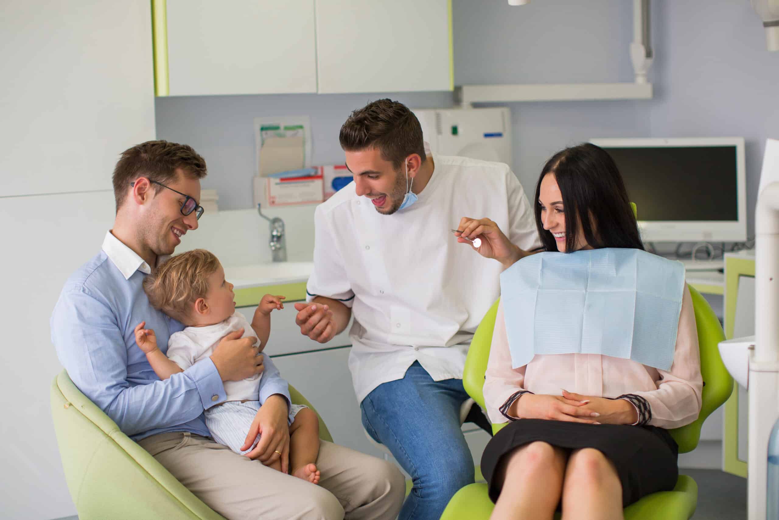 Pregnant woman with her family at dentist before treatment.