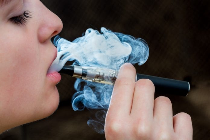 Closeup detail of Female with an Electronic Cigarette, Horizontal shot