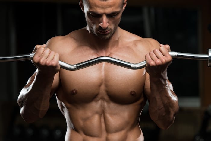 Muscular Man Doing Heavy Weight Exercise For Biceps