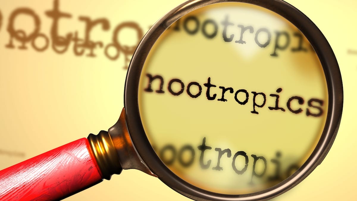 Close-up of magnifying glass examining the word 'Nootropics