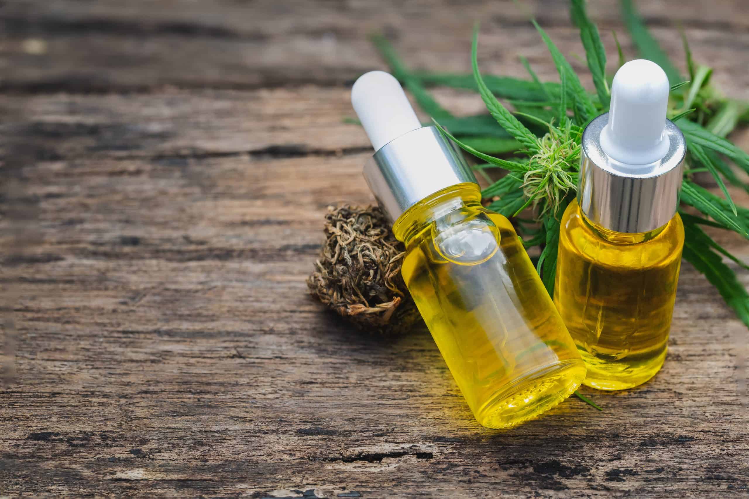 Cannabis herb and leaves with oil extracts in jars. medical concept, marijuana oil hemp products.