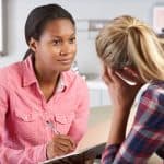 Teenage Girl Visits Doctor's Office Suffering With Depression