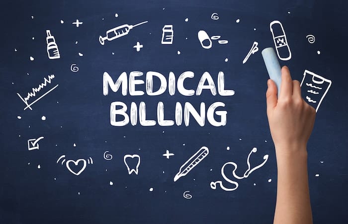 Hand drawing MEDICAL BILLING inscription with white chalk on blackboard, medical concept