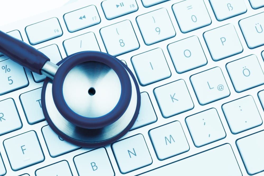 a stethoscope and a keyboard of a computer