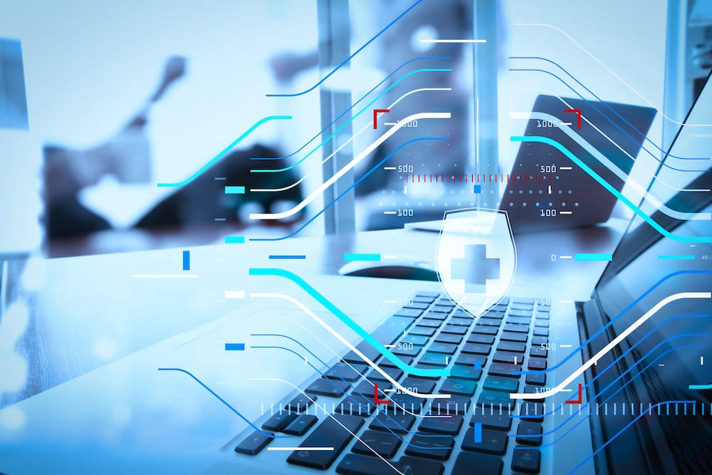 Health protection. Medical and health care concept.business documents on office table with smart phone and laptop and two colleagues discussing data in the background