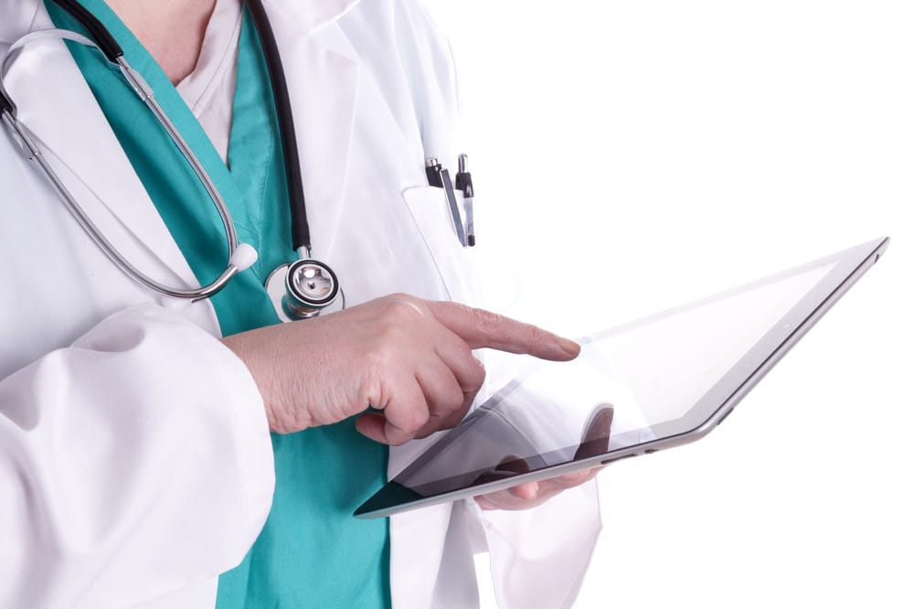 Female doctor is using a digital tablet in her work. The Digital Hospital, with new and modern resources and easy access to the important information about the patients, test results and patient registration