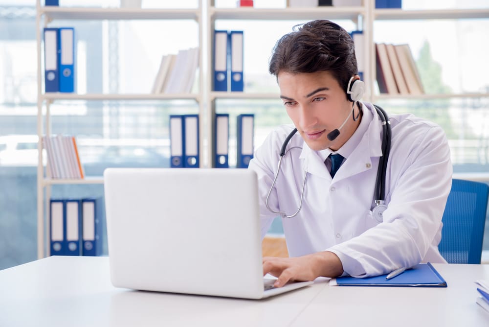 Young male doctor in telehealth concept