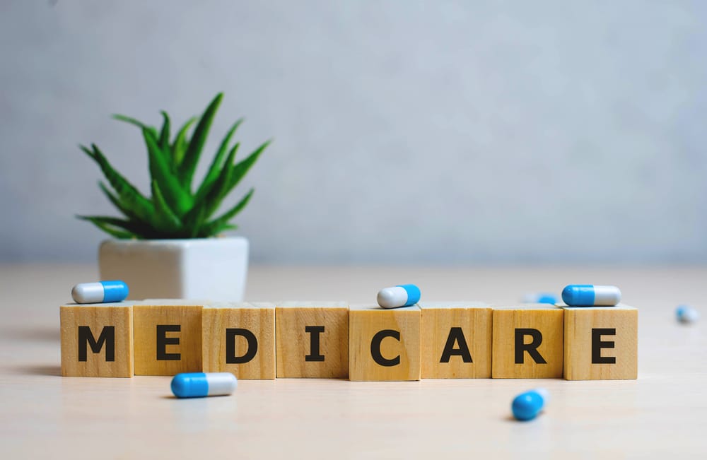 MEDICARE word made with building blocks, medical concept background.