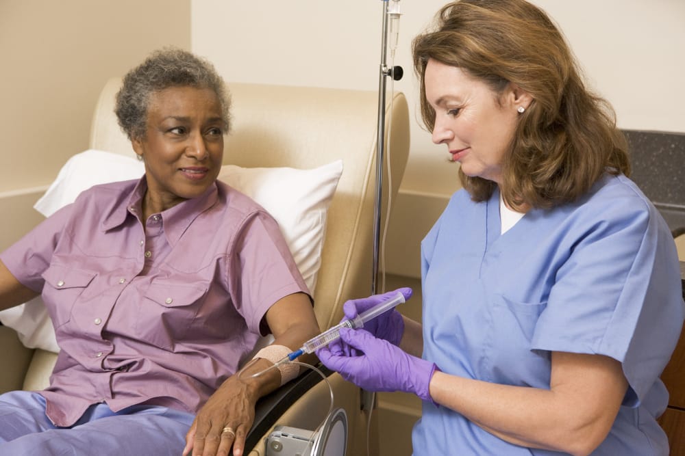 Nurse Giving Patient Injection of Oncology Drugs