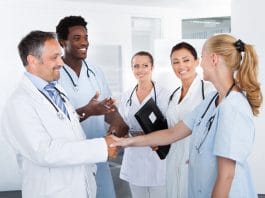 Portrait Of Successful Multiracial Doctors In Clinic
