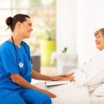 friendly nurse visiting recovering senior patient