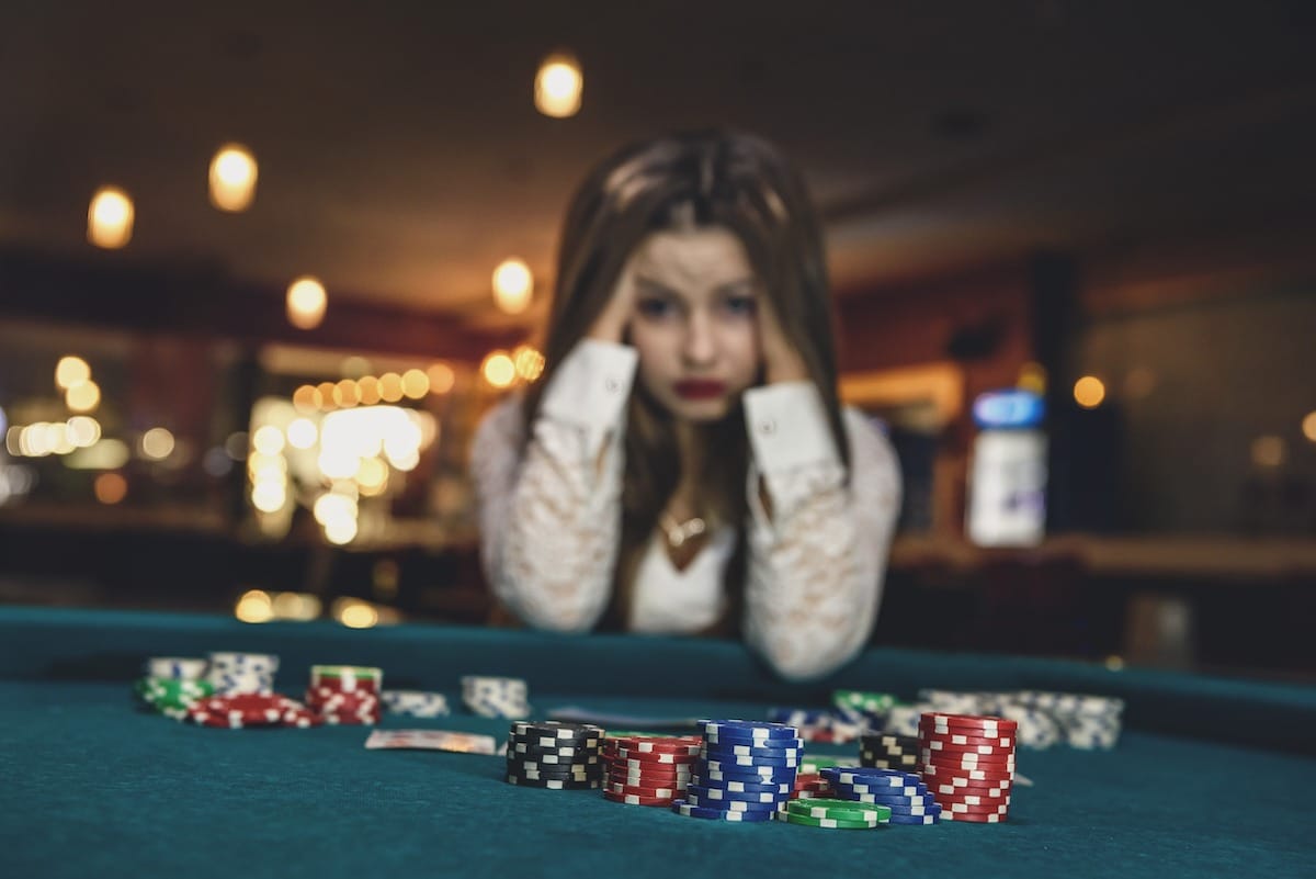 young woman who lost money at a casino blackjack table