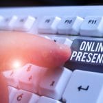 Person pushing a keyboard button with the words Online Presence
