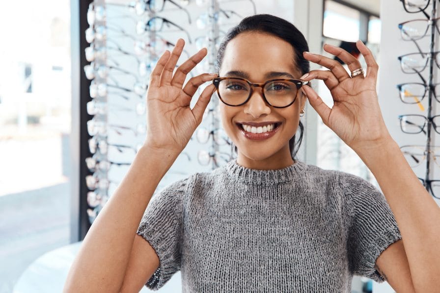 The best eyewear brands in the optometry business. Shot of a young woman buying a new pair of glasses at an optometrist store