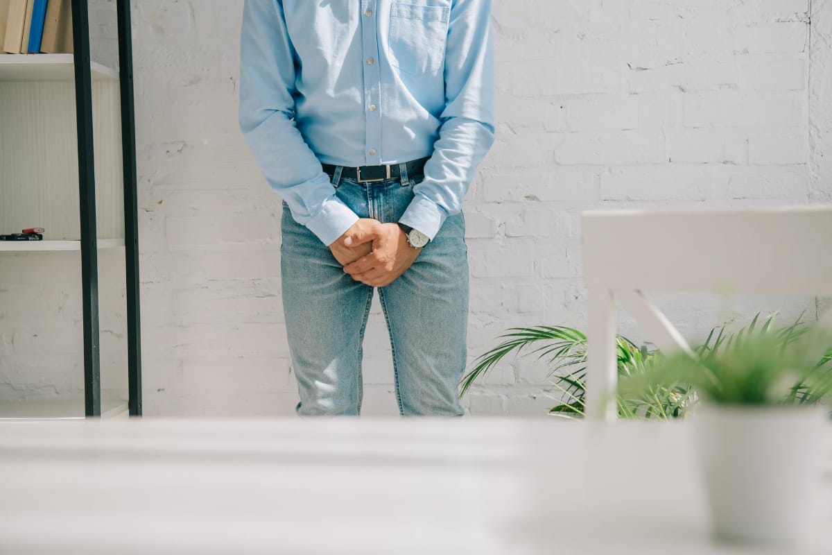 Our Prostadine Review hero image features a man holding his crotch, while discussing prostate health with his doctor