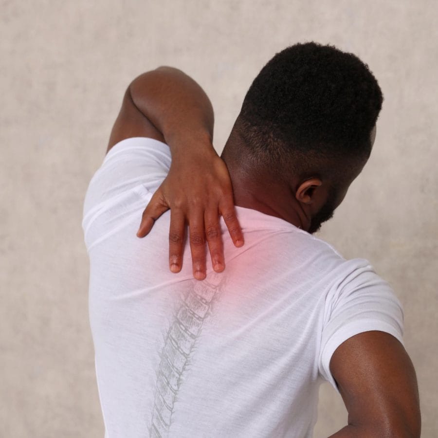 What Is the Fastest Way to Heal a Sore Tailbone Pain? 2 An image of a person sitting in a sitting or standing position, leaning forward to relieve tailbone pain