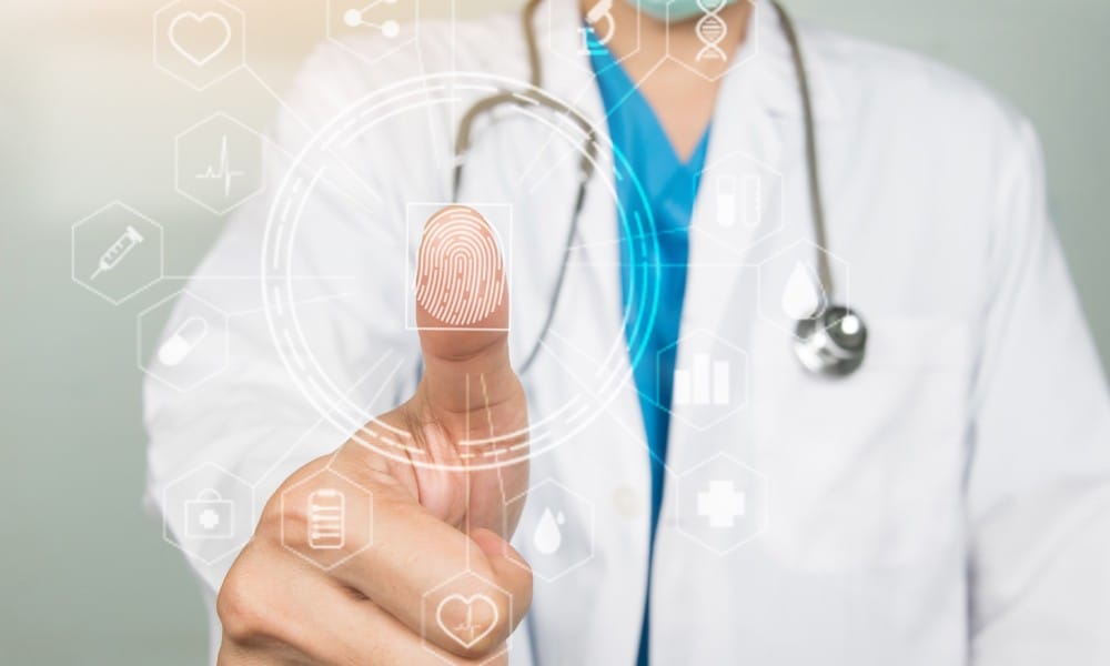 A doctor holding his thumb up to the camera with a digital overlay showing a fingerprint.