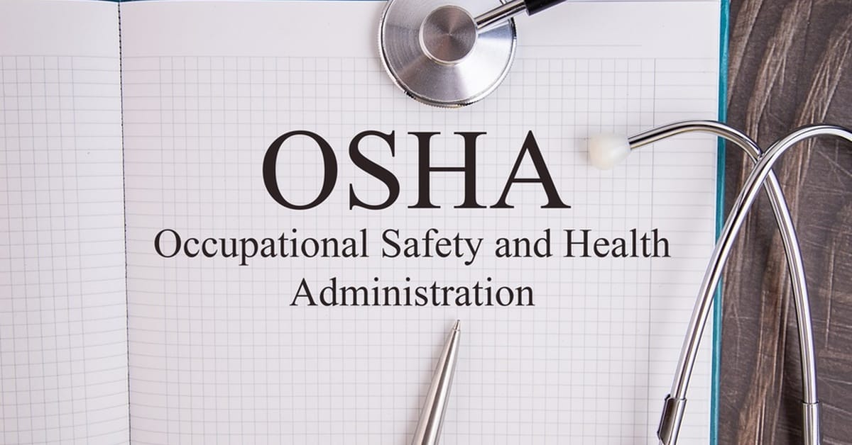 A turquoise notebook with grid paper lies open and reads "OSHA Occupational Safety and Health Administration."